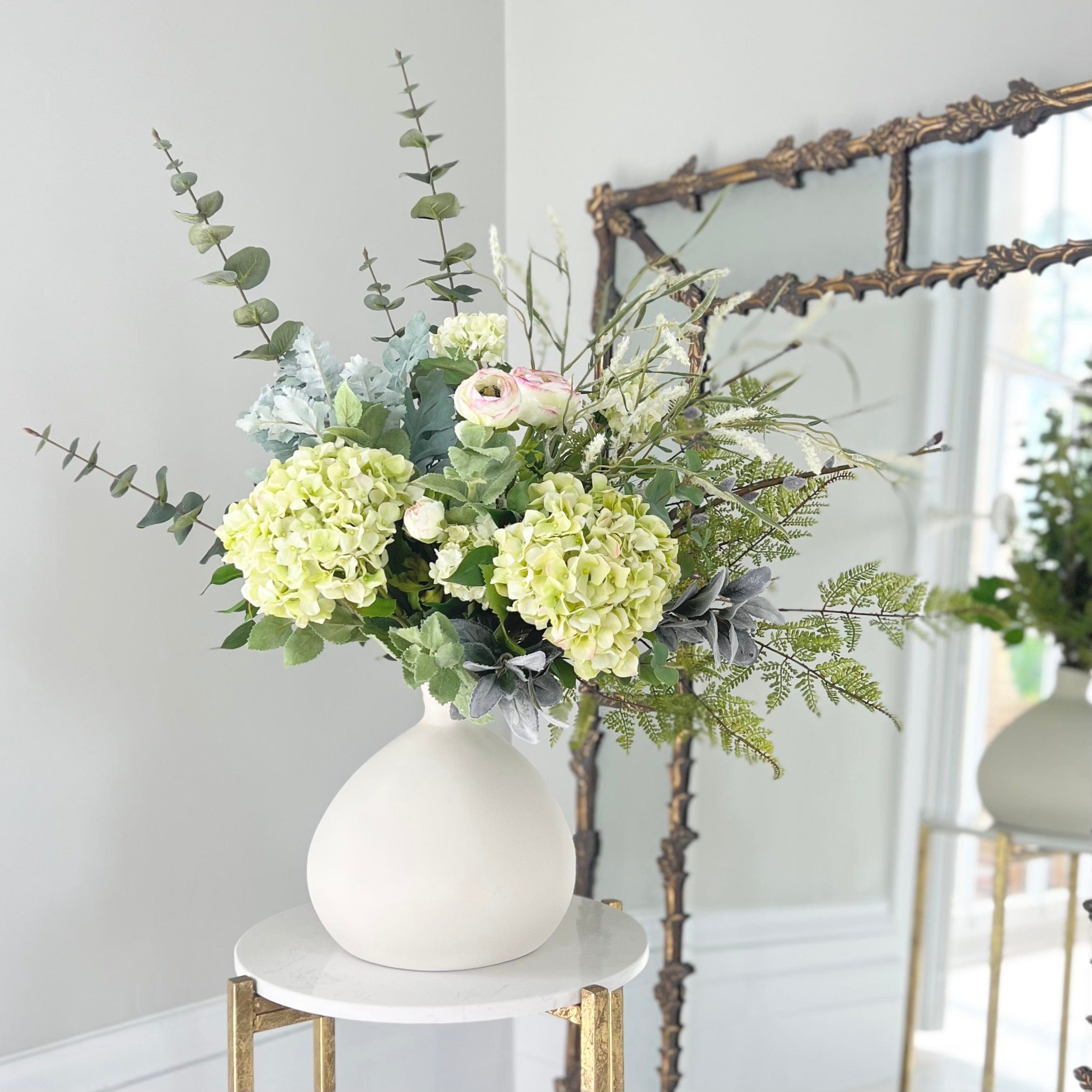 Green artificial flowers in shop vase