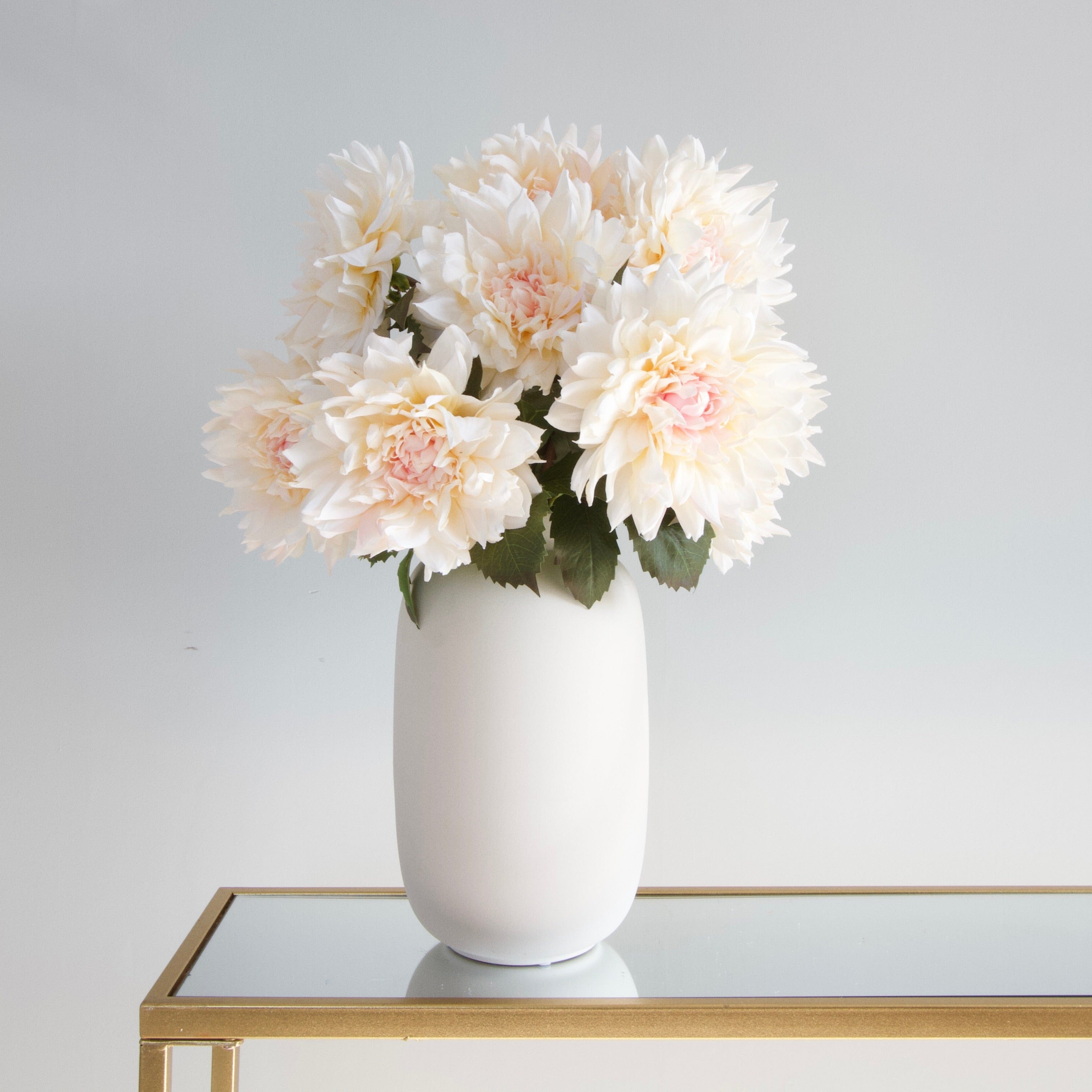 Luxury Lifelike Realistic Artificial Fabric Silk Blooms with Foliage Buy Online from The Faux Flower Company | 12 stems of Pale Pink Cafe Au Lait Dahlia ABY2216 styled in Ceramic Matte White Kingham Vase ABP04B3